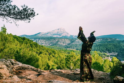 Mature woman wearing kimono while standing on mountain