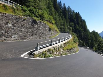 High angle view of road amidst trees against sky