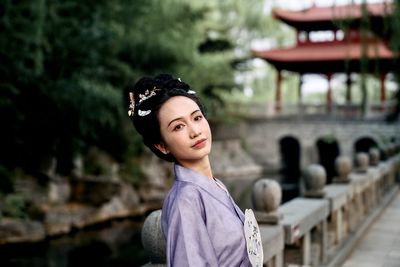 Portrait of young woman standing outdoors
