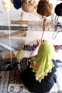 Rear view of woman sitting outdoors