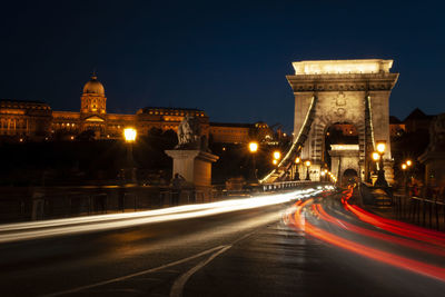 Illuminated bridge against sky at night