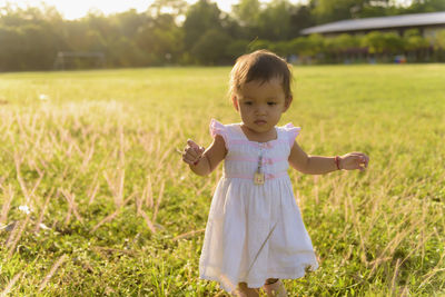  asian baby girl walking in the meadow with copy space happy family day concept. silhouette.