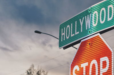 Low angle view of road sign against sky