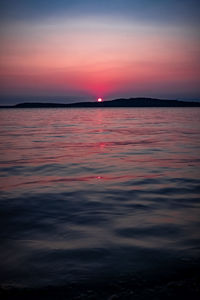 Scenic view of sea against romantic sky at sunset