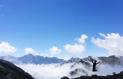 Scenic view of snowcapped mountains against blue sky