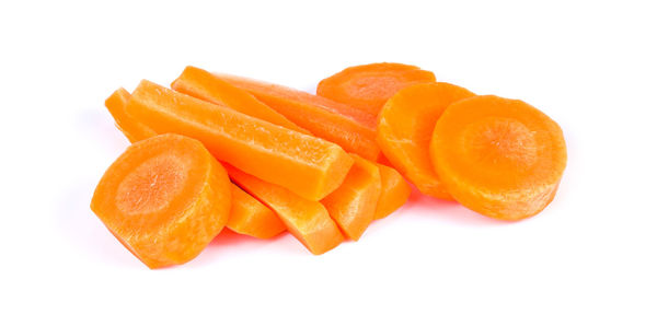 Close-up of orange slices over white background