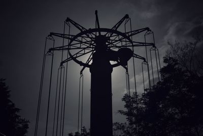 Low angle view of silhouette statue against sky