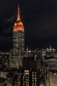 Low angle view of illuminated empire state building against sky at night