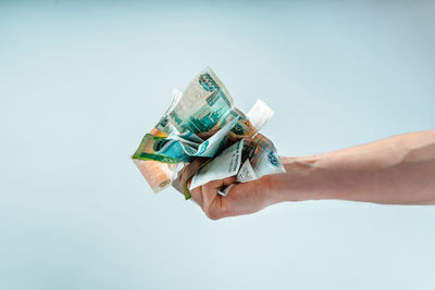 Midsection of woman holding gift against white background