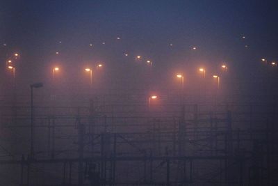 Illuminated lights against sky at night