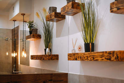 Decorative shelves and mirror in bathroom at home