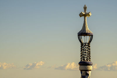 Low angle view of spire against sky during sunset