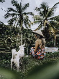 Full length of woman with palm trees