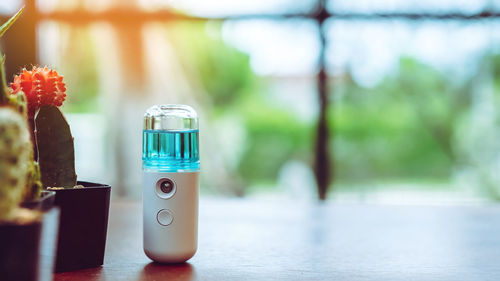 Close-up of small glass bottle on table