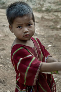 Portrait of cute boy standing outdoors