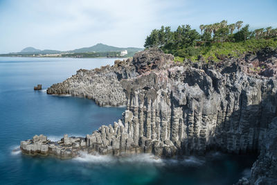 Panoramic view of rocks on sea against sky