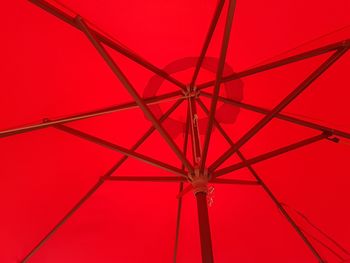 Low angle view of red umbrella against clear sky