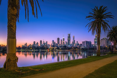 Scenic view of the city skyline reflected in the lake during sunset in melbourne australia.
