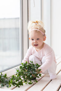 Portrait of boy playing with christmas tree at home