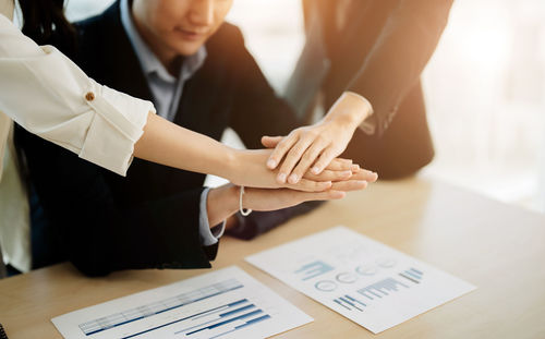 Midsection of business people shaking hands