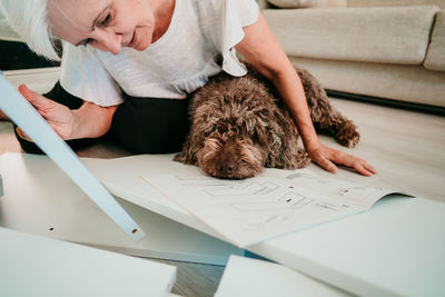 Portrait of woman with dog on table