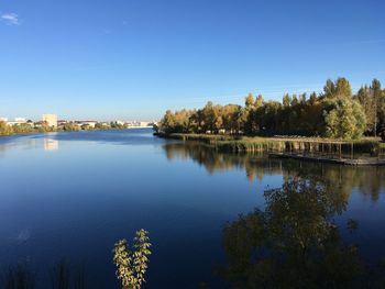 Scenic view of lake against clear blue sky