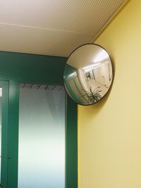 Close-up of light bulb hanging on ceiling