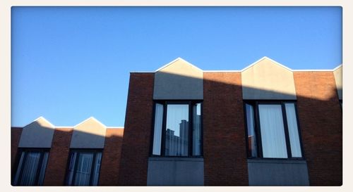 Low angle view of building against clear blue sky