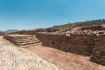 View of old ruins against clear blue sky