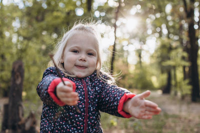 Portrait of cute girl gesturing in park