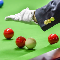 Close-up of hand playing with ball on table