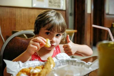 Boy eating in restaurant