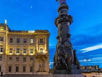 Statue of historic building against blue sky