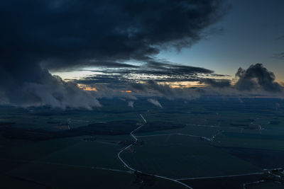Aerial view of snow covered landscape against sky