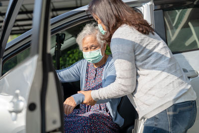 Asian senior woman patient sitting on walker prepare get to her car, healthy strong medical concept.