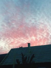 High section of house against cloudy sky