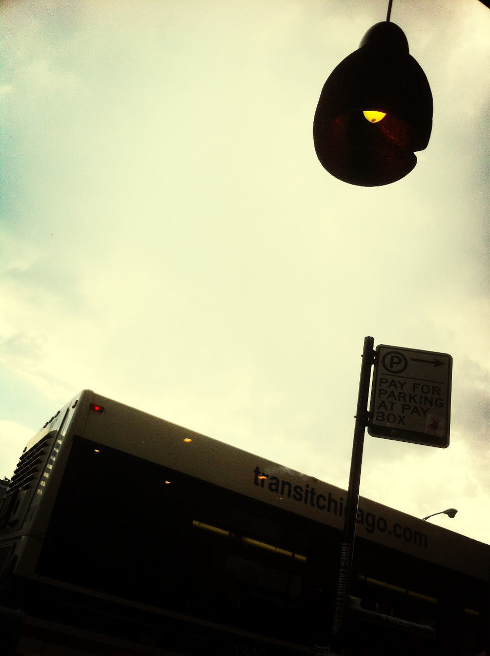 low angle view, communication, text, sky, built structure, architecture, western script, sign, guidance, road sign, building exterior, information sign, capital letter, street light, information, lighting equipment, outdoors, no people, cloud - sky, dusk