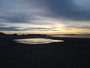 Scenic view of beach against sky during sunset