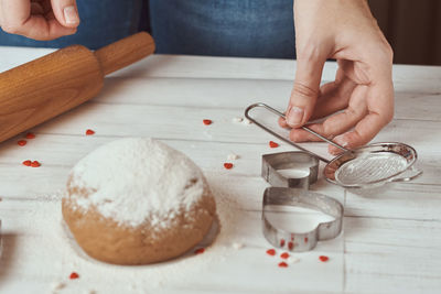 Midsection of person preparing food on table