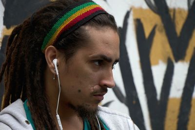 Portrait of young man looking away outdoors