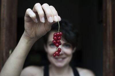 Close-up of woman holding strawberry