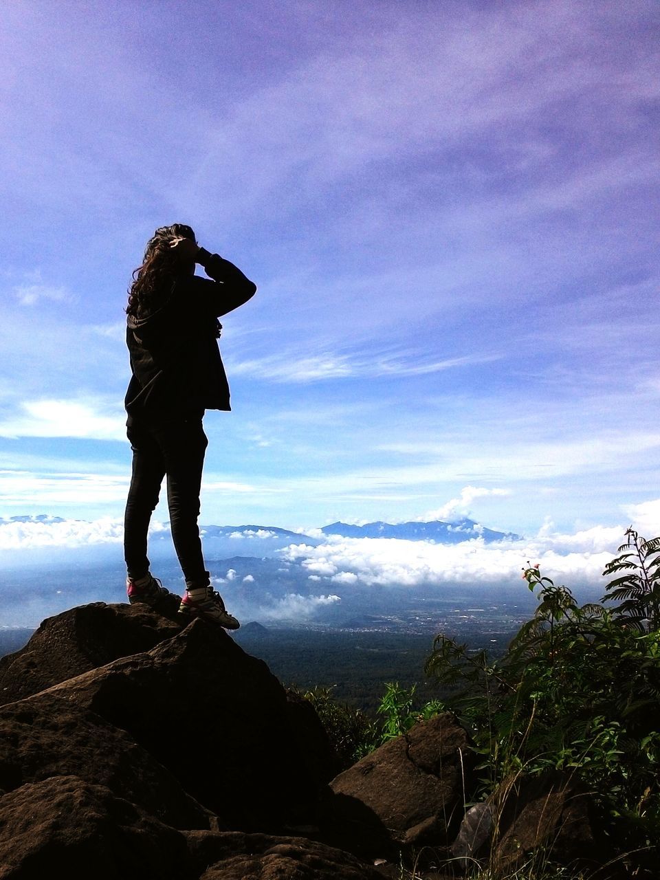 sky, leisure activity, lifestyles, standing, tranquility, tranquil scene, mountain, scenics, cloud - sky, rear view, beauty in nature, full length, men, nature, landscape, rock - object, getting away from it all, cloud