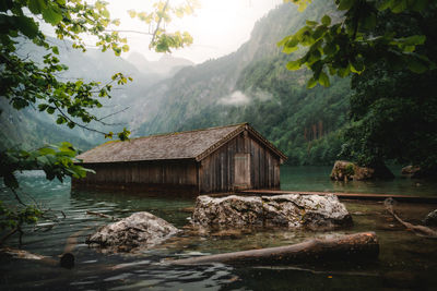 Building by mountain against sky