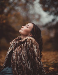 Portrait of a young woman looking up