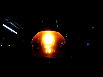 Close-up of illuminated light bulb in dark