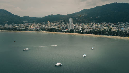 High angle view of sea and buildings in city