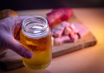 Cropped hand of person holding beer cane