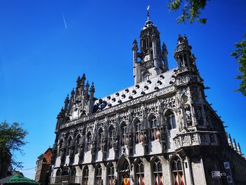 Low angle view of temple building against blue sky