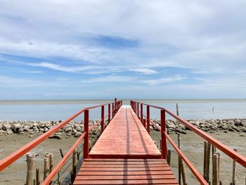 Pier over sea against sky