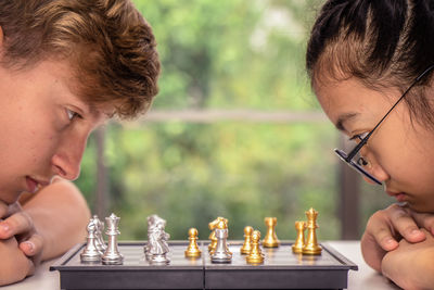 Friends playing chess at home